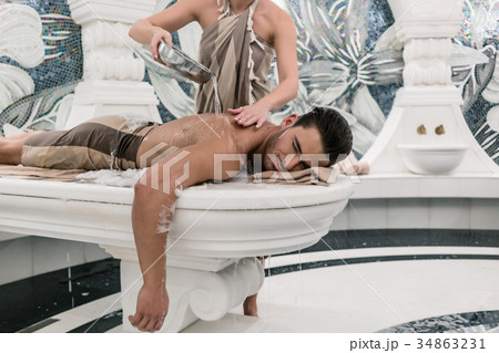 Relaxed man lying down on hot marble bed during 34863231