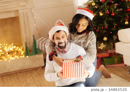 Loving woman hugging her husband on Christmas Eve 34863520
