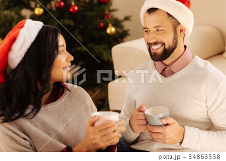 Happy couple drinking coffee together on Christmas 34863538