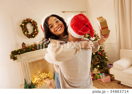 Happy woman thanking her husband for Christmas Happy woman thanking her husband for Christmas 34863714