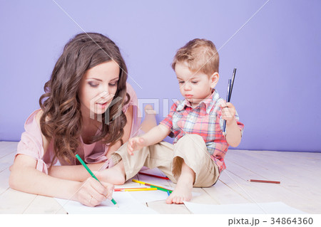 mother and young son play paint crayons mother and young son play paint crayons 34864360