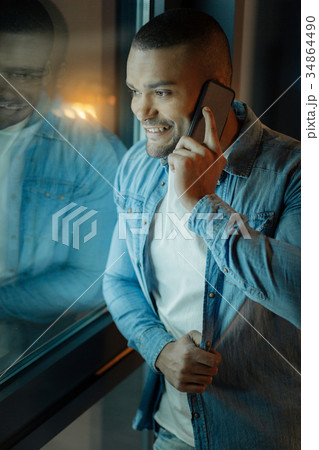 Confident mulatto touching his shirt Confident mulatto touching his shirt 34864490