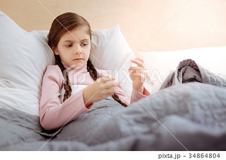 Curious girl holding a little pillbox 34864804