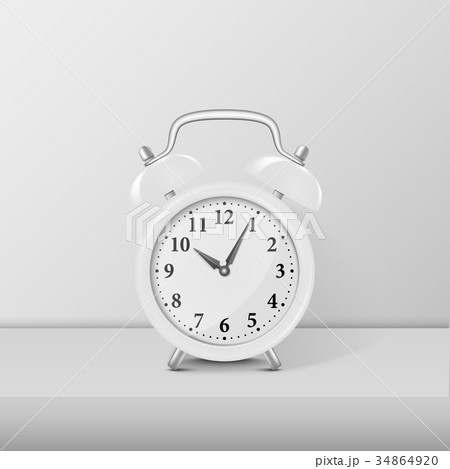 White alarm clock closeup standing on white table 34864920