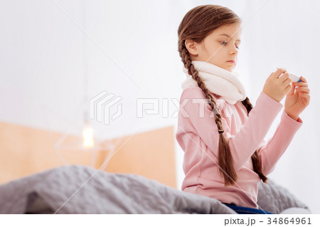 Curious girl measuring the temperature while 34864961