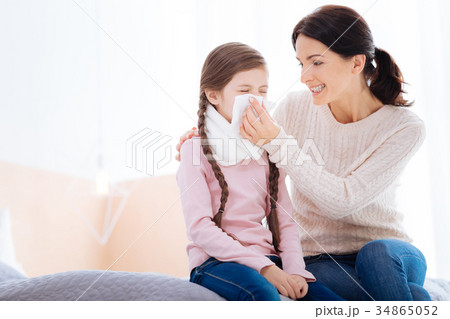 Happy woman holding a napkin for her daughter 34865052
