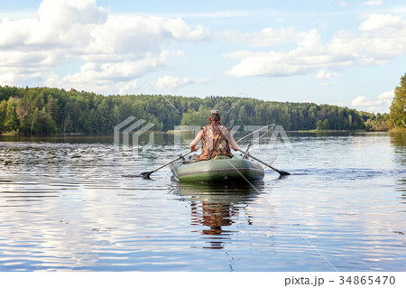 A fisherman in a boat 34865470