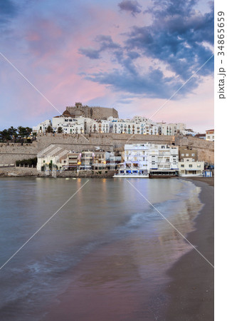 Spain, Valencian Community, Peniscola, Waterfront town at sunset 34865659