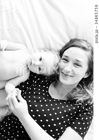 Portrait of baby girl (6-11 Months) with mother, directly above 34865759