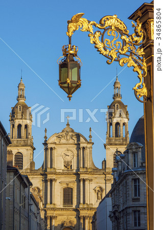 France, Grand Est, Nancy, Ornate street light with Nancy Cathedral in background 34865804