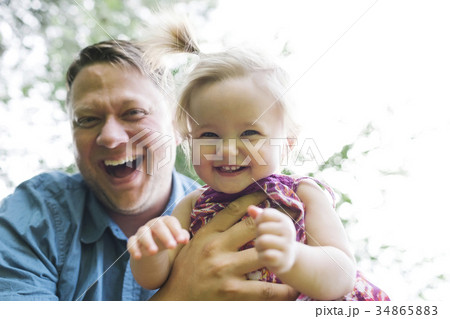 Father playing with baby girl (12-17 months) in backyard 34865883