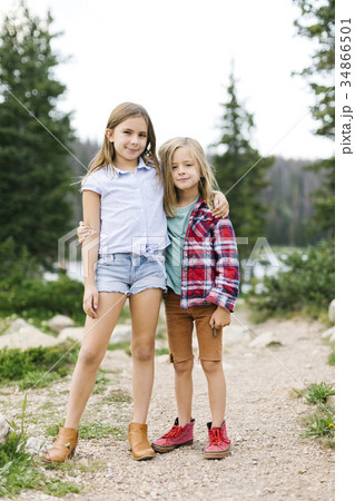 Outdoor portrait of brother (6-7) and sister ( 8-9) in forest 34866501