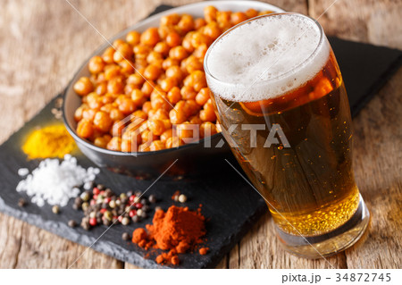 Roasted salted chickpeas with beer close-up Roasted salted chickpeas with beer close-up 34872745