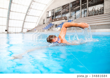 Man swimming in an indoor swimming pool. Man swimming in an indoor swimming pool. 34881684