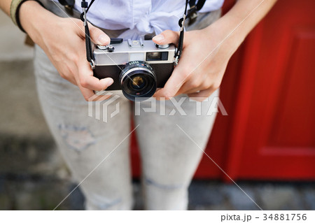 Unrecognizable tourist with camera in the old town 34881756