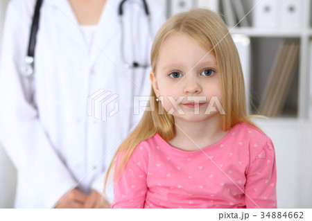 Unhappy cute baby  after health exam at doctor' 34884662