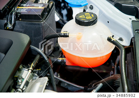 Close up Coolant container in a car's engine bay 34885932