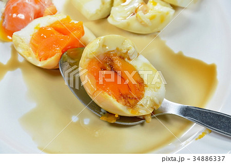 boiled egg with creamy yolk on spoon boiled egg with creamy yolk on spoon 34886337