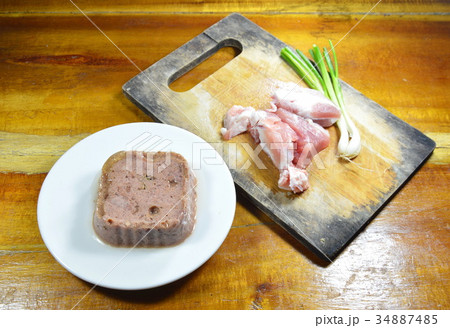 dog premium wet food and fresh raw pork on block 34887485