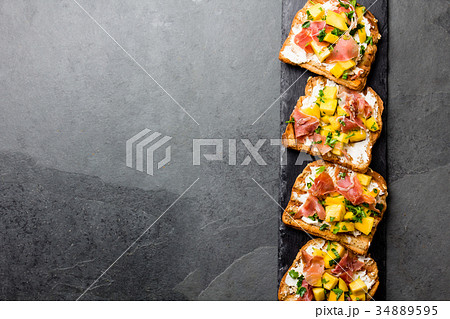 Toasts with cream cheese, ham jamon serrano and Toasts with cream cheese, ham jamon serrano and 34889595