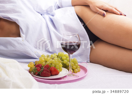 girl in a shirt on a white bed girl in a shirt on a white bed 34889720