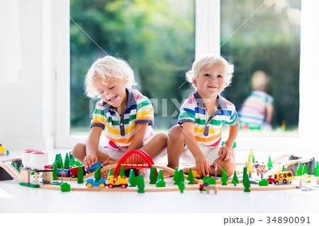 Children play wiht toy train. Kids wooden railway. Children play wiht toy train. Kids wooden railway. 34890091