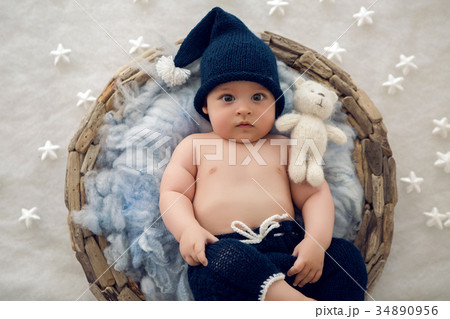 baby boy lying in a basket with fur hat-knitting baby boy lying in a basket with fur hat-knitting 34890956