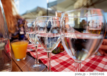 Row of pure drinking water glasses at summer Row of pure drinking water glasses at summer 34893406