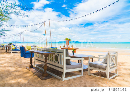 Chair and table dinning on the beach and sea with blue sky 34895141