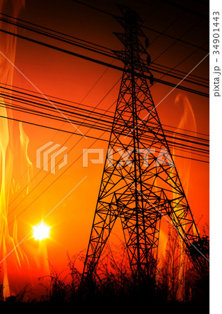 High voltage pole with a flame burning sunset High voltage pole with a flame burning sunset 34901443