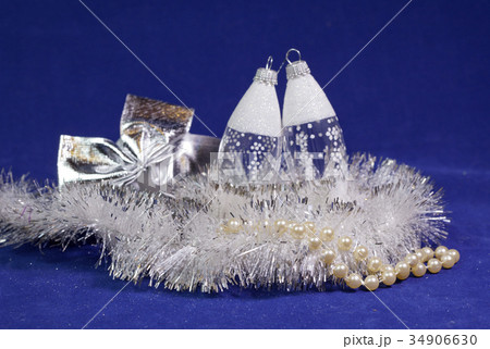 white New Year balls and tinsel on a blue backgrou white New Year balls and tinsel on a blue backgrou 34906630