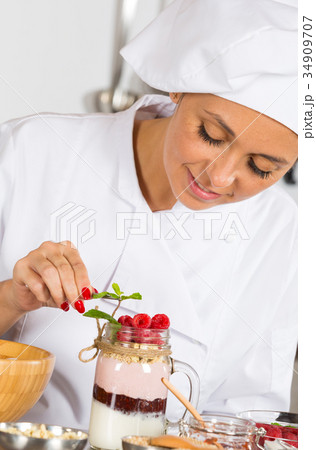 Cook making a dessert Cook making a dessert 34909707