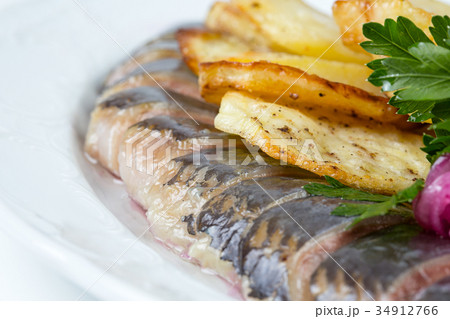 Fried potato, onion and herring 34912766