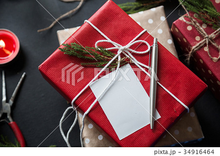A christmas gift with greetings card on the table 34916464