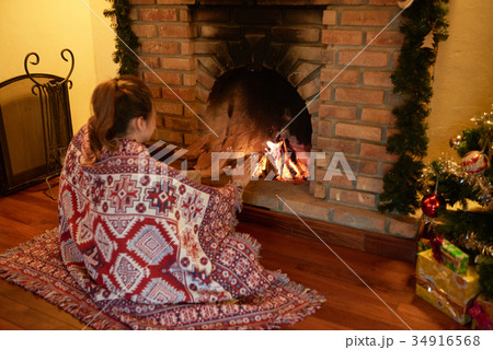 Warming hands near fireplace Warming hands near fireplace 34916568