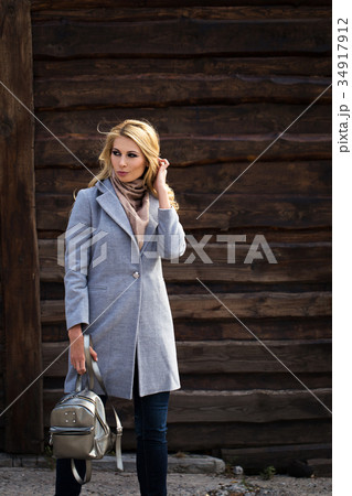 Beautiful girl in a gray coat. On the street 34917912