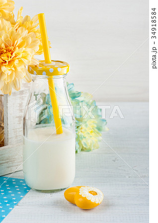 Bottle of milk with straw and yellow heart 34918584