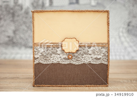 Decorated wedding guest book on the wooden table 34919910