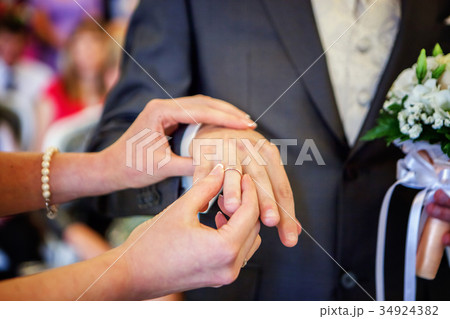 the bride wears a ring to the groom the bride wears a ring to the groom 34924382