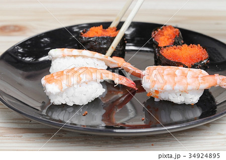 hand holding sushi chopsticks on plate wooden hand holding sushi chopsticks on plate wooden 34924895