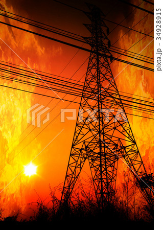 High voltage pole with a flame burning sunset High voltage pole with a flame burning sunset 34928915