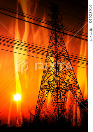 High voltage pole with a flame burning sunset 34928916
