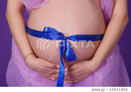 Pregnant young lady woman posing in front camera Pregnant young lady woman posing in front camera 34931903