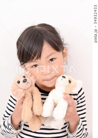 犬の人形を持つ女の子 の写真素材