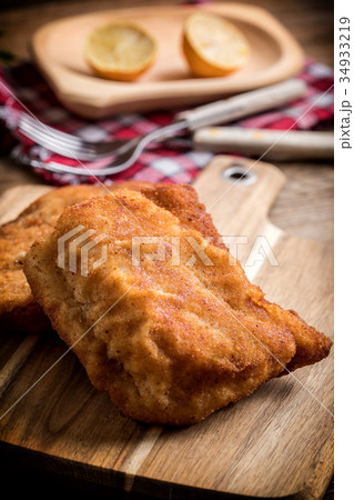Two fried cod fillet pieces. 34933219