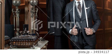 Tailor hands expensive tailoring individual suits Tailor hands expensive tailoring individual suits 34934117