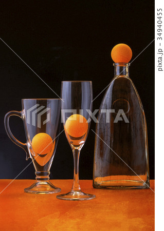 Still life with orange balls and glass objects 34940455