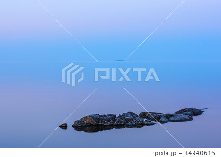Tranquil minimalist landscape with rocks in water 34940615