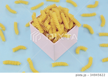 Uncooked italian pasta on blue background. Uncooked italian pasta on blue background. 34945622