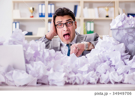 Businessman in paper recycling concept in office Businessman in paper recycling concept in office 34949706